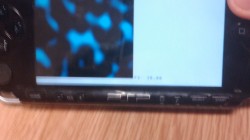 A picture of the PlayStation Portable Developer kit with a simplex noise rendering on the screen.