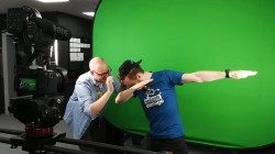 A picture of Luc Shelton (myself) posing or "dabbing" in front of a green screen for the media and marketing team.
