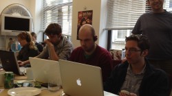 The game jam teams that are still working away into the morning. In the picture is David Jones, Kevin Chandler, and on the far end is Jo Twist, the CEO of UKIE.