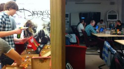 Some of the team hard of work while others grab pizza.